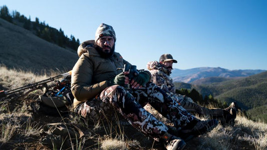Hunters with Moxule hunting packs resting on mountain ridge for elk scouting