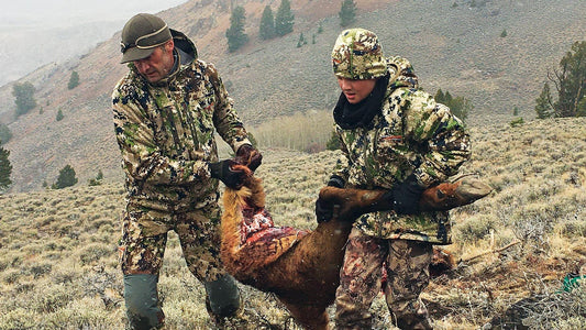 April whitetail deer hunting success, two hunters with harvested deer in mountain terrain, perfect spring deer hunt with hunting backpacks.