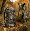 Moxule Camo Hunting Backpack & Bino Harness in autumn forest. Features silent design, waterproof fabric, and quick-access optics pocket for deer hunting.
