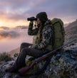 Female Hunter Using Binocular Harness at Mountain Overlook | Moxule Hunting Gear