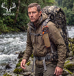 Lifestyle image of backcountry hunter hiking by mountain stream, Moxule bear spray pouch securely mounted on hunting backpack for wilderness safety during elk and deer hunts.