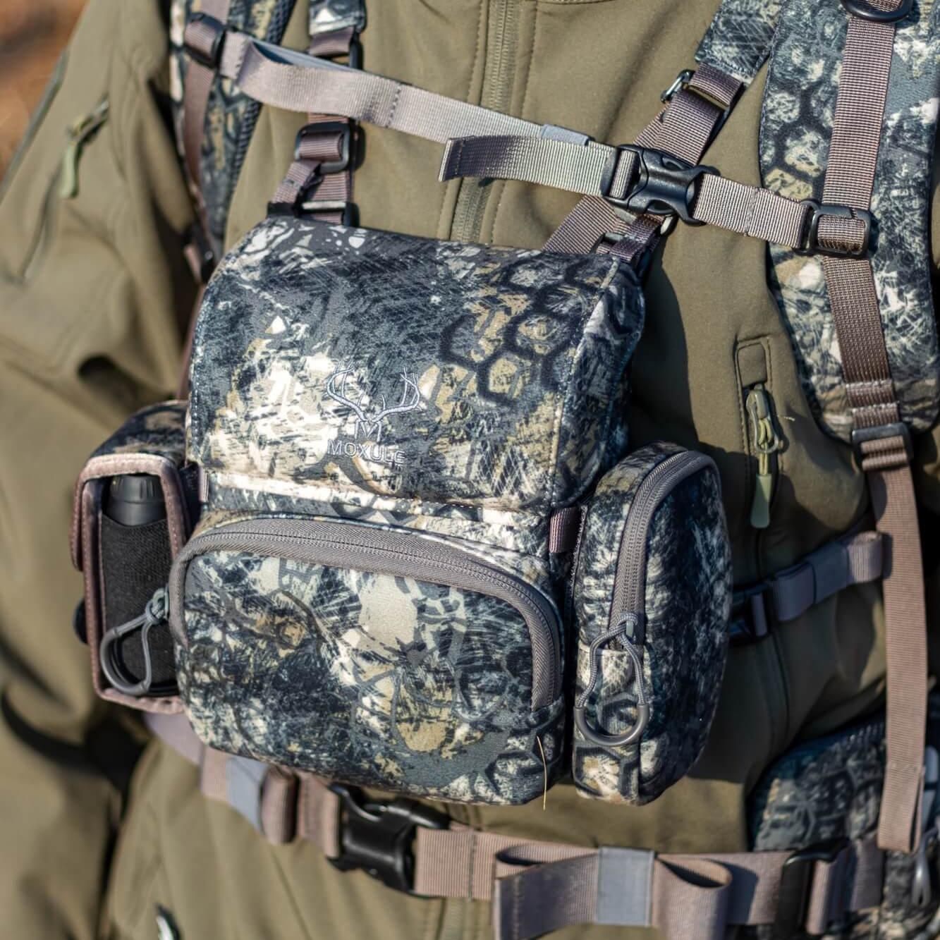MOXULE camo binocular harness:adjustable straps, multi-pocket storage for hands-free hunting optics carry.