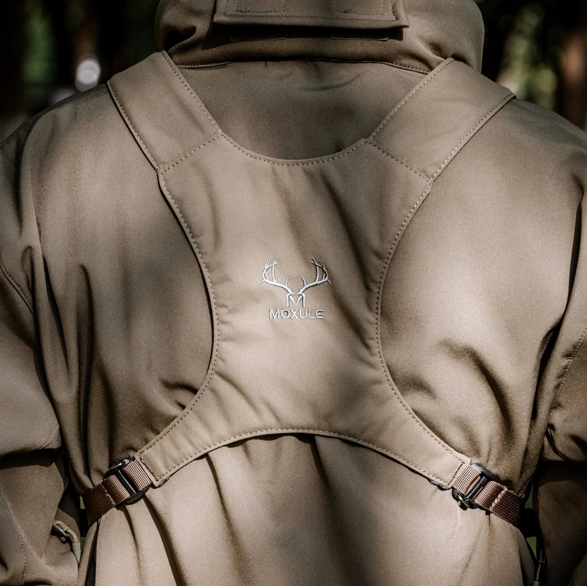 MOXULE binocular harness back panel with breathable ergonomic design, adjustable straps, and durable fabric, ideal for hunting and outdoor wildlife observation.