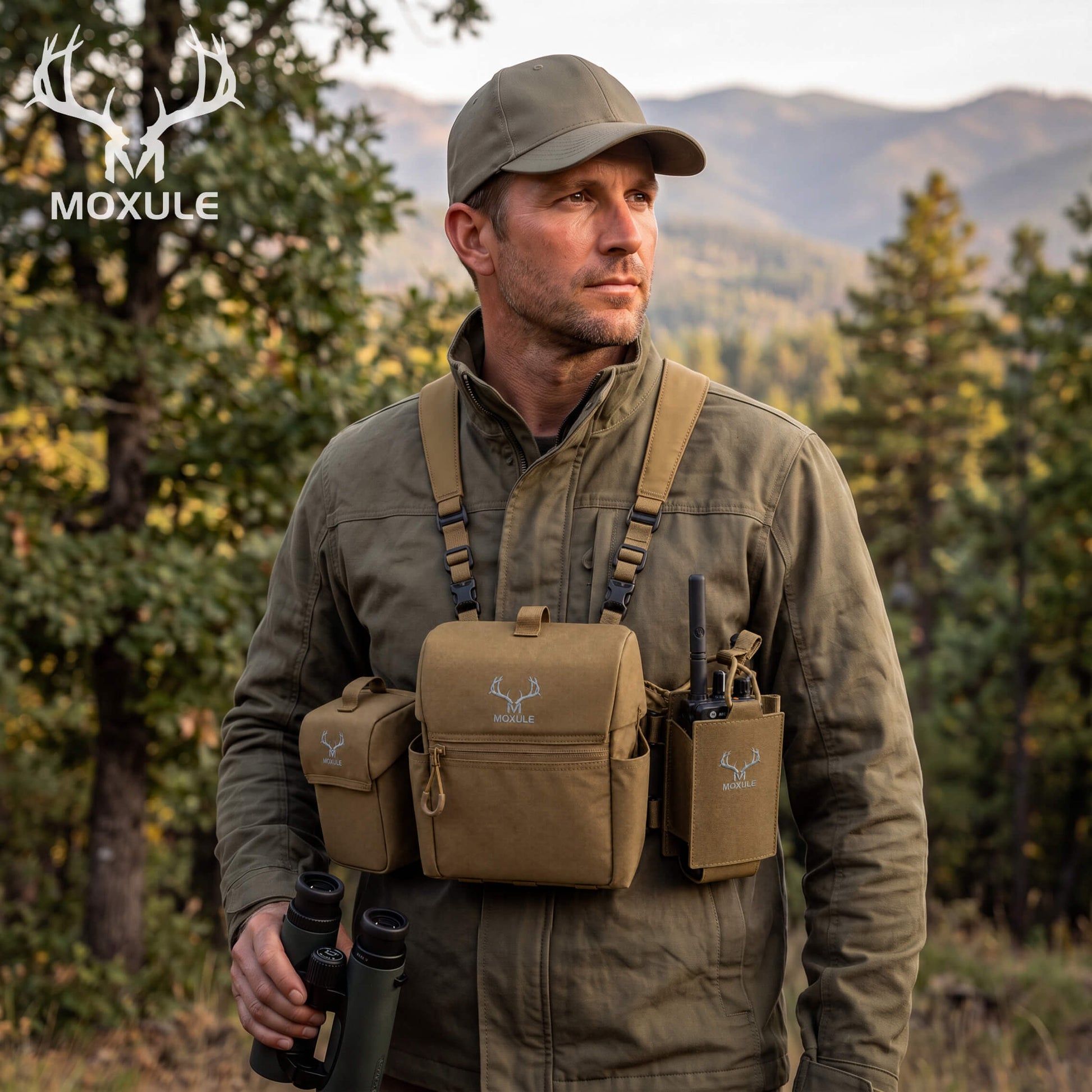Moxule hunting gear field lifestyle shot, hunter wearing binocular chest harness with MOLLE radio pouch and accessories in fall backcountry woods