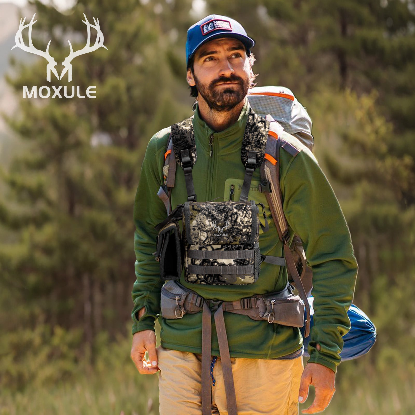 Hunter wearing Moxule camouflage binocular chest pack and hunting backpack in forest outdoor scene, 