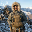 Hunter wearing Moxule coyote brown modular binocular chest pack with detachable hand muff in snowy mountain winter hunting scene.